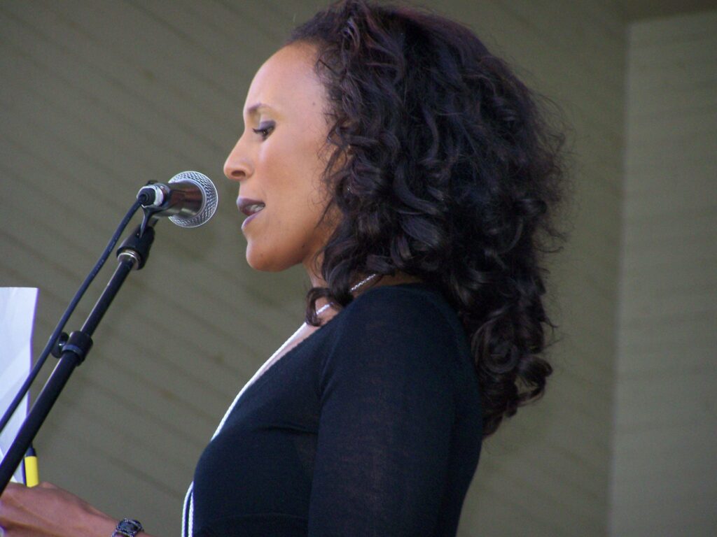 Co-Host Judy Gabrield 3 - a woman with curly hair