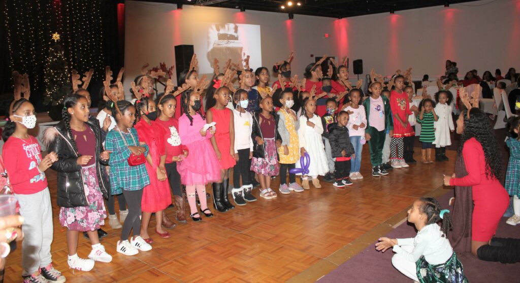 Community Actives Kids - a group of children standing on a wooden floor