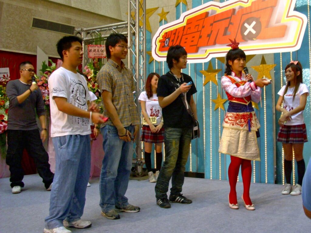 File:CTS Super Game Crazy Press Conference interactive games.jpg - a group of people standing around