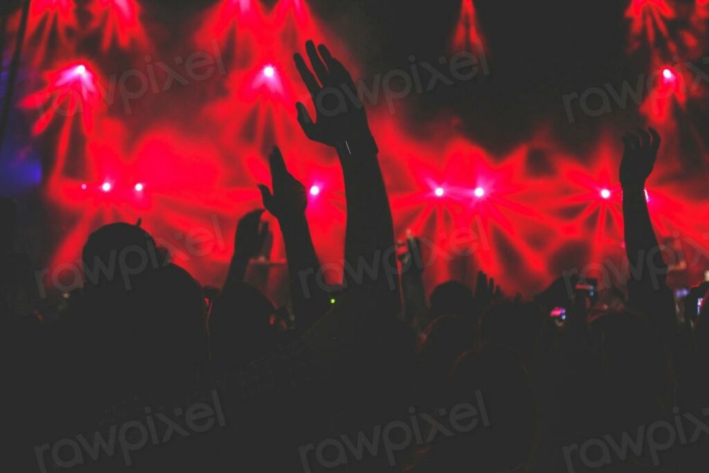 Free crowd at concert image - a crowd at a concert with their hands up