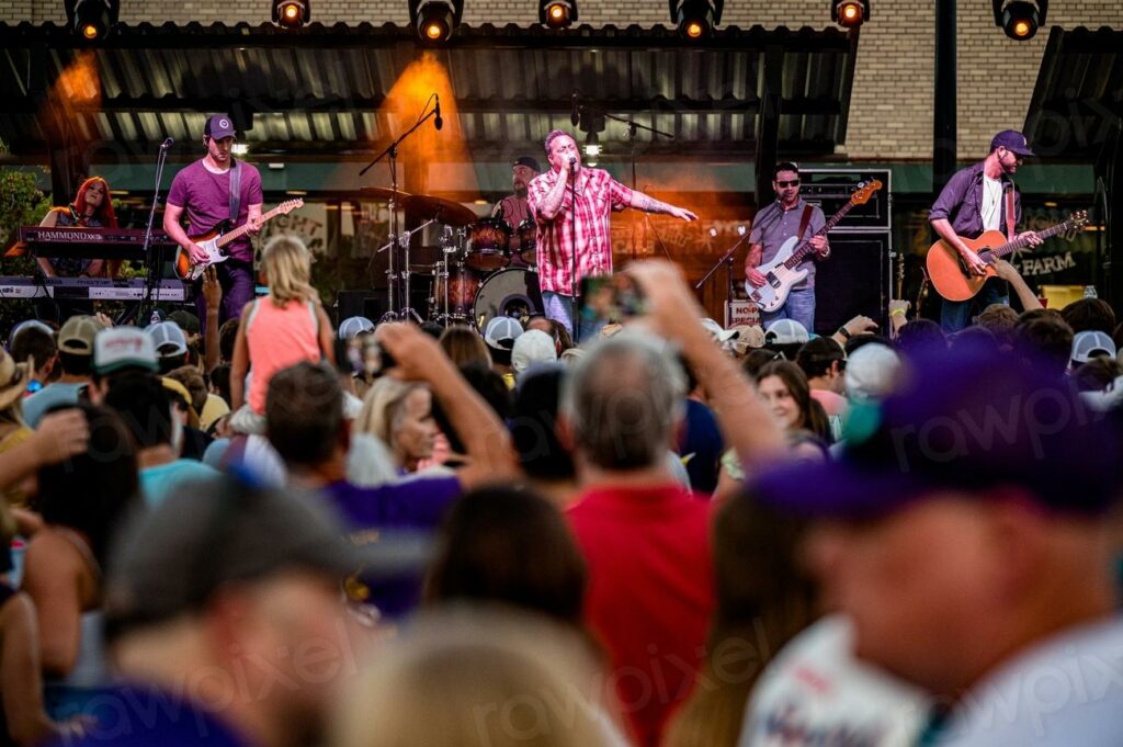 Alex Butler and Uncle Kracker - a crowd of people watching a band perform