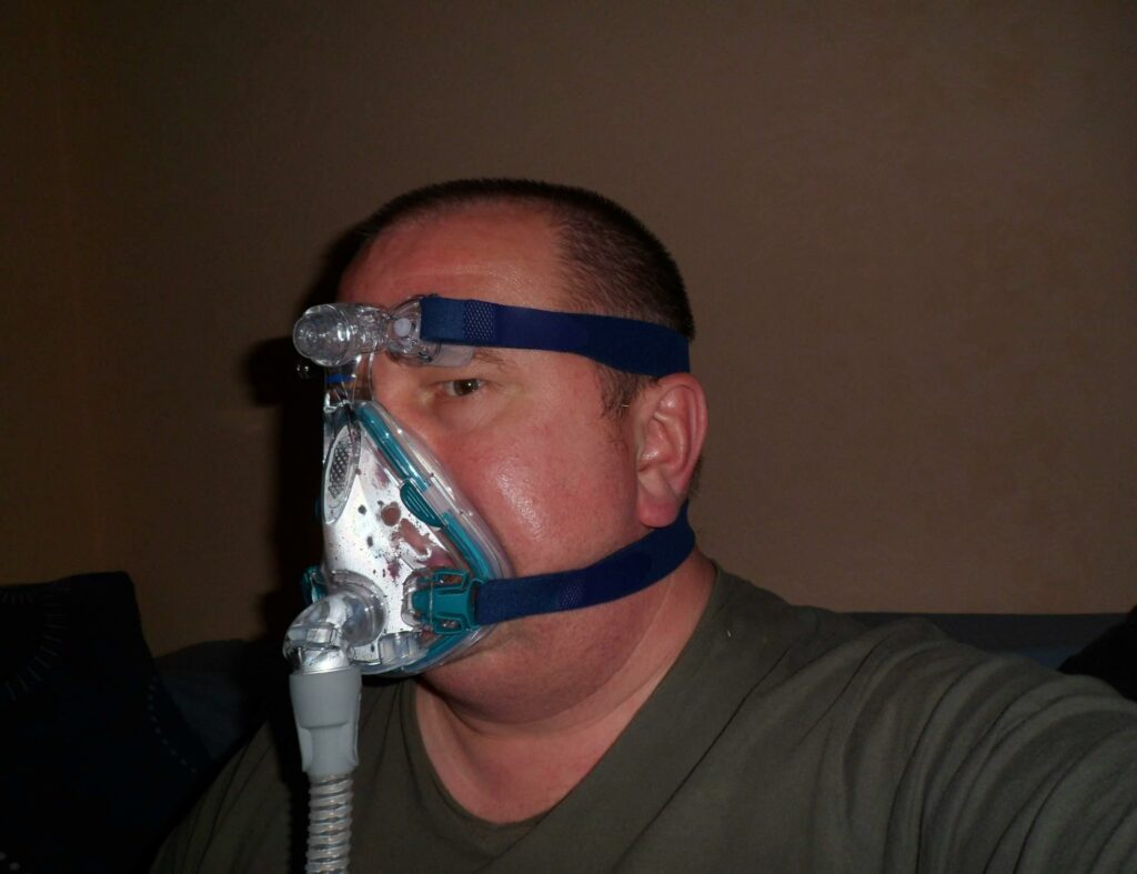 CPAP-mirage-quatro-full-face-mask - a man with a mask and a mask on