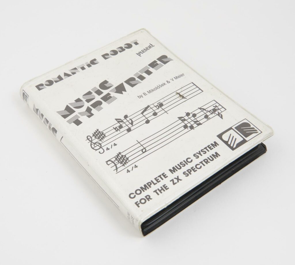 Cassette, 'Music Typewriter' (video game) - a white book with black and white music notes