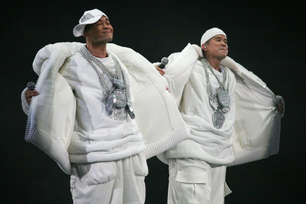 File:Bling Bling (206625150).jpg - two men dressed in white clothing and holding a white umbrella